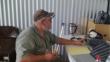 KE4HIE (biscuit in hand) checking one of the HF stations. - Field Day 2021
